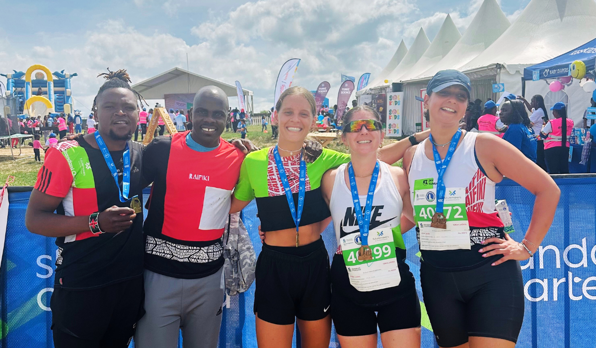 Kenyan runners celebrating together after a race
